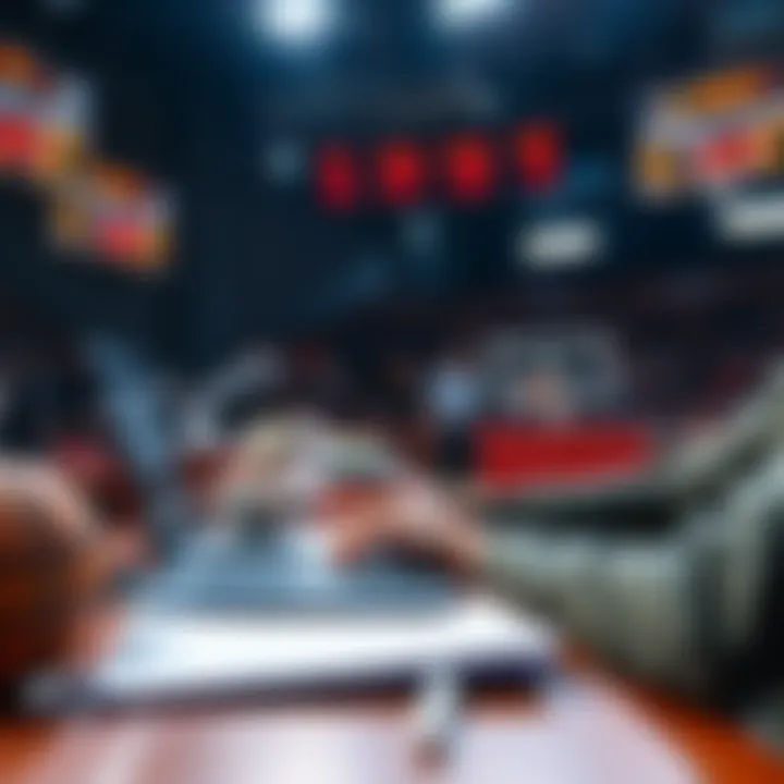 A person analyzing basketball game stats and placing bets with a laptop and notes on a table