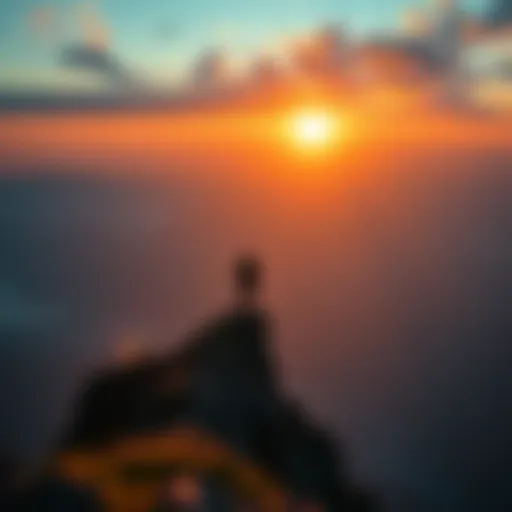 A person standing on a mountain peak looking at a sunrise, symbolizing the realization of dreams and aspirations.