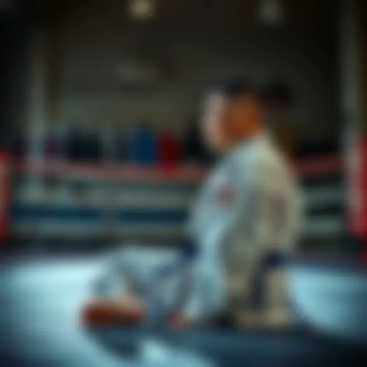 A martial artist sits on the mat, looking contemplative after a tough competition, with a backdrop of training gear and a dimly lit gym.