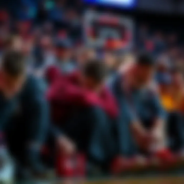 A group of frustrated basketball fans sitting with their heads down, expressing disappointment about betting on 76ers games.