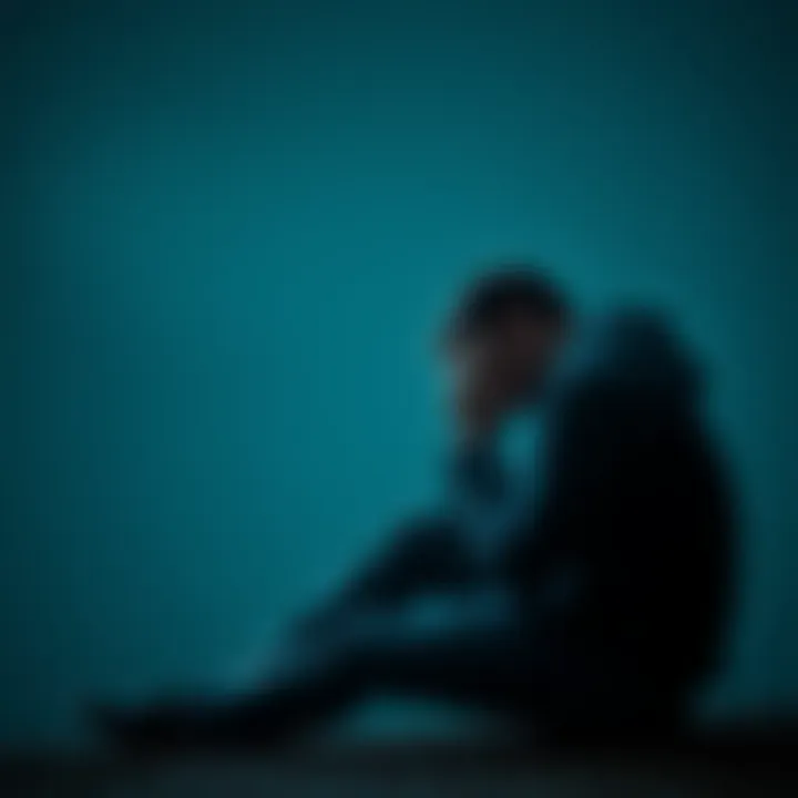 A person sitting alone, looking sad with their head in their hands, reflecting on emotional pain
