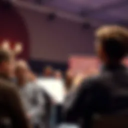 A person stands in front of an audience holding a script, while some audience members laugh humorously at the presentation.