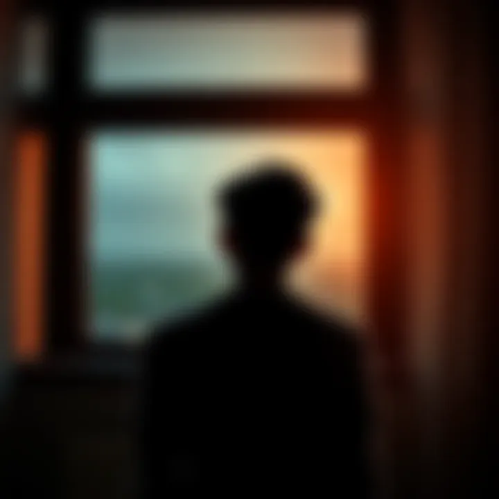 Reflection on Loss A person sitting alone with a thoughtful expression, looking out a window, symbolizing introspection about loss and poverty.