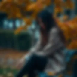 Sad woman sitting alone A woman with a sad expression sitting on a bench, surrounded by autumn leaves, reflecting on her feelings of depression and loss.
