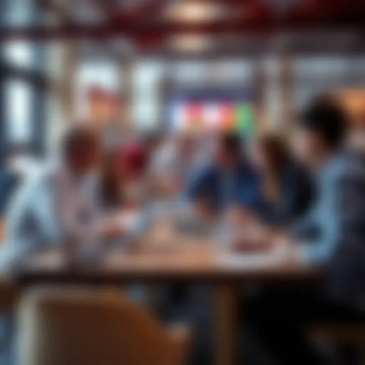 Group of people discussing soccer betting strategies around a table with laptops and notebooks