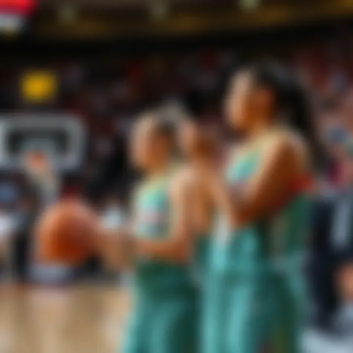 A basketball game in progress showcasing Indiana Fever players Caitlin Clark and Sophie Cunningham, with fans cheering in the background.